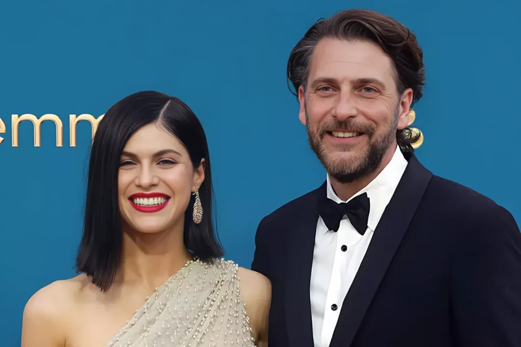Alexandra Daddario and Andrew Form smiling at the Emmy Awards red carpet event