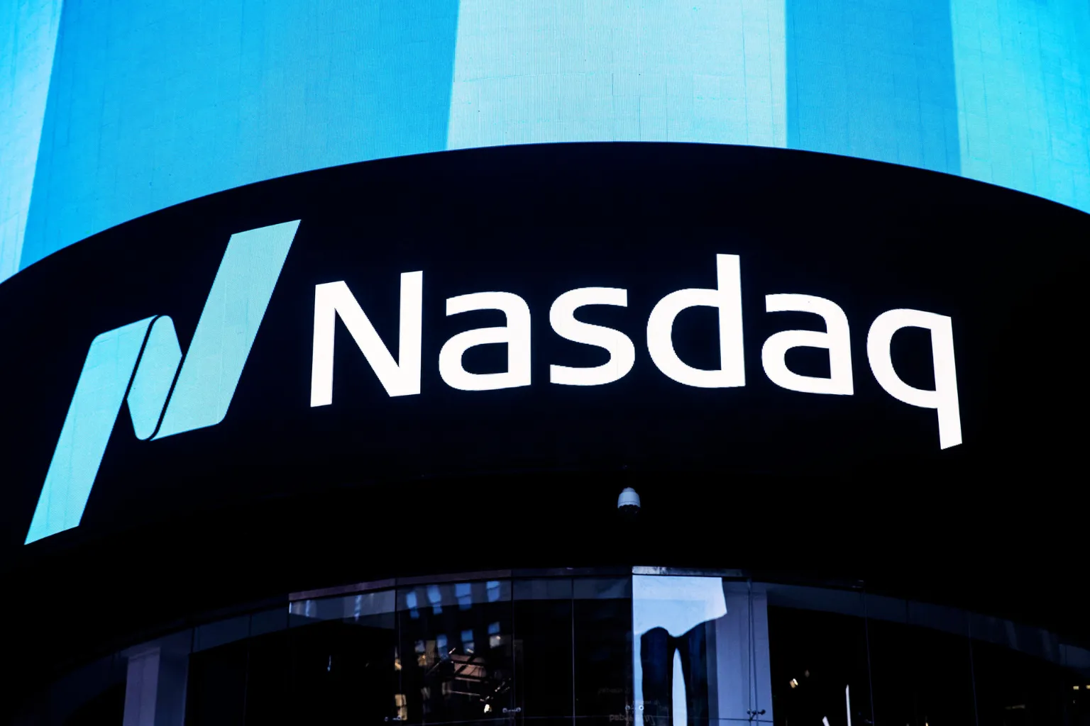 Nasdaq Composite Plunges on Trump Tariff Hike 1 Nasdaq Composite index logo displayed at market site, representing tech stock market performance.