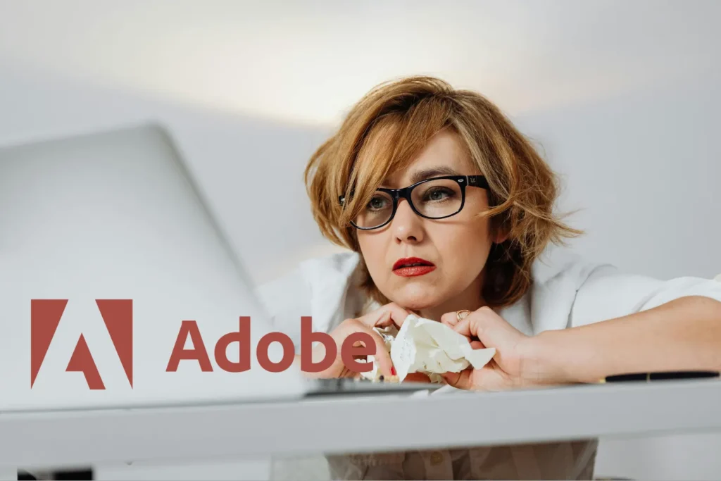 Frustrated investor analyzes Adobe stock price forecast 2026 with AI and earnings data on laptop
