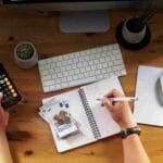 budgeting tips for beginners with calculator, notebook, and cash for saving money and managing personal finances