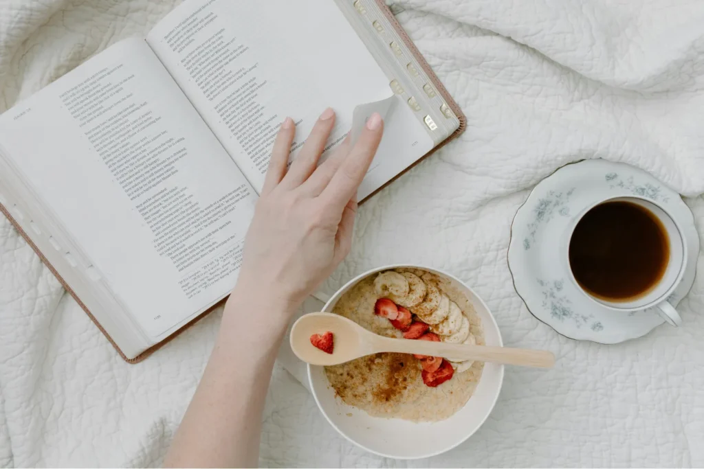 daily habits for personal growth morning routine reading book healthy breakfast and coffee on bed