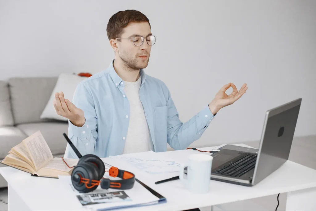 Man practicing mindfulness at desk to develop self discipline daily and build focus for success