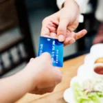 Person paying with EBT card benefits for food benefits at a restaurant counter