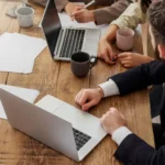 Woman working on laptop with headphones learning how to find remote jobs from home online