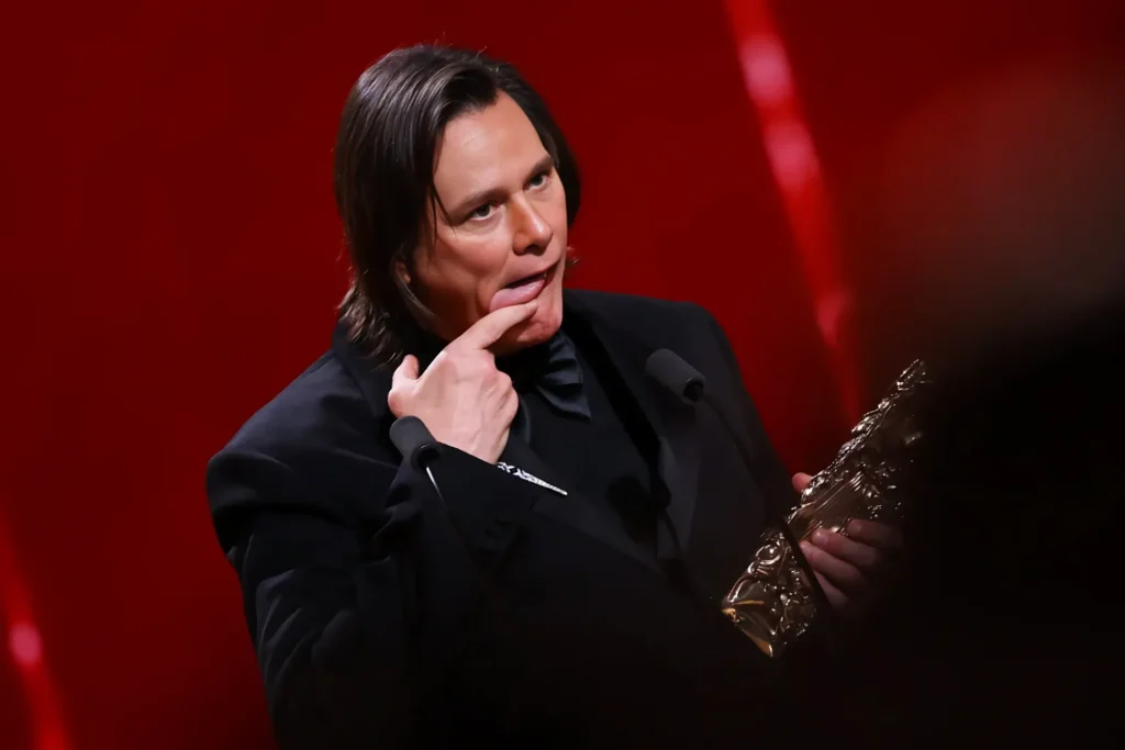 Jim Carrey Award Speech – Net Worth & Career Earnings Jim Carrey reacts during his award acceptance speech, reflecting decades of blockbuster success and wealth growth.