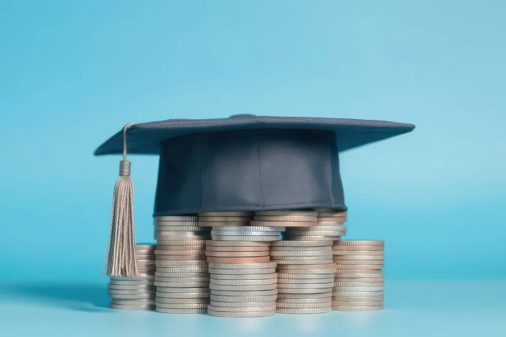 Student Loan Debt and Graduation Costs Under Treasury Control Graduation cap on stacked coins showing impact on Treasury takeover federal student loan debt in the US