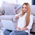 Woman working on laptop at home representing work from home jobs for female without experience and beginner online income opportunities